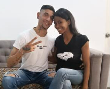 Couple posing together in a room