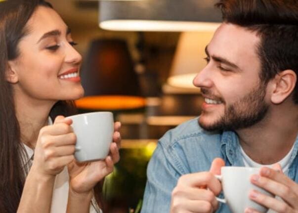 Couple chatting over coffee in a warm lifestyle setting