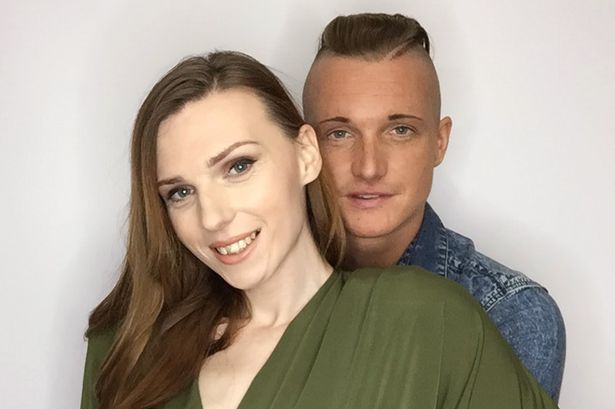 Trans couple portrait with a clean studio background